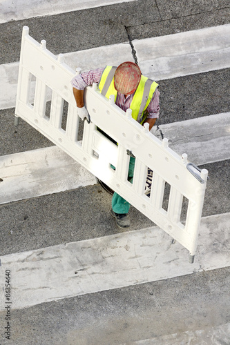  worker placing the protective plastic barriers