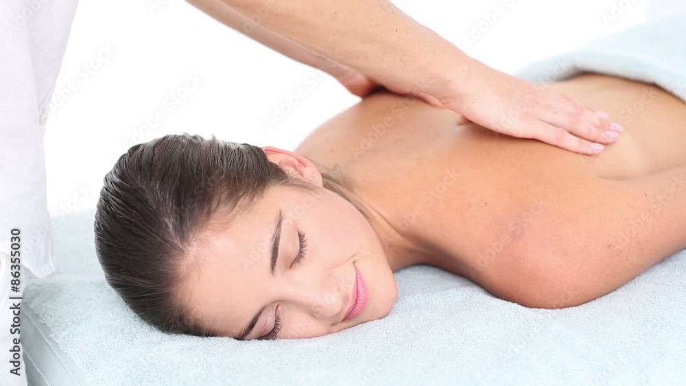 Attractive woman receiving back massage at spa center Attractive woman receiving back massage at spa center