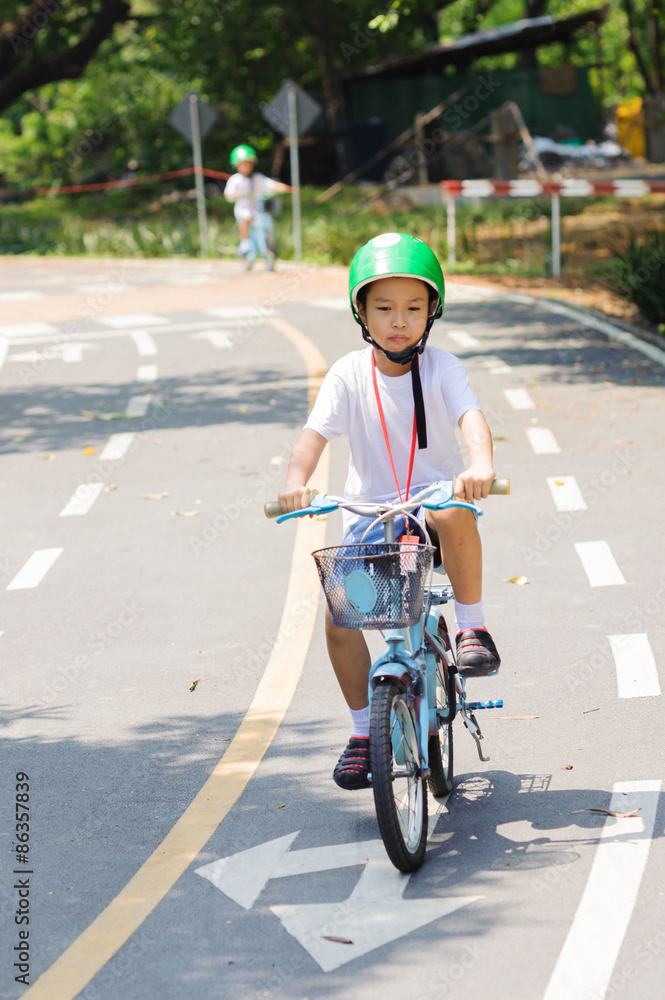 Fototapeta premium Boy practice biking on the road