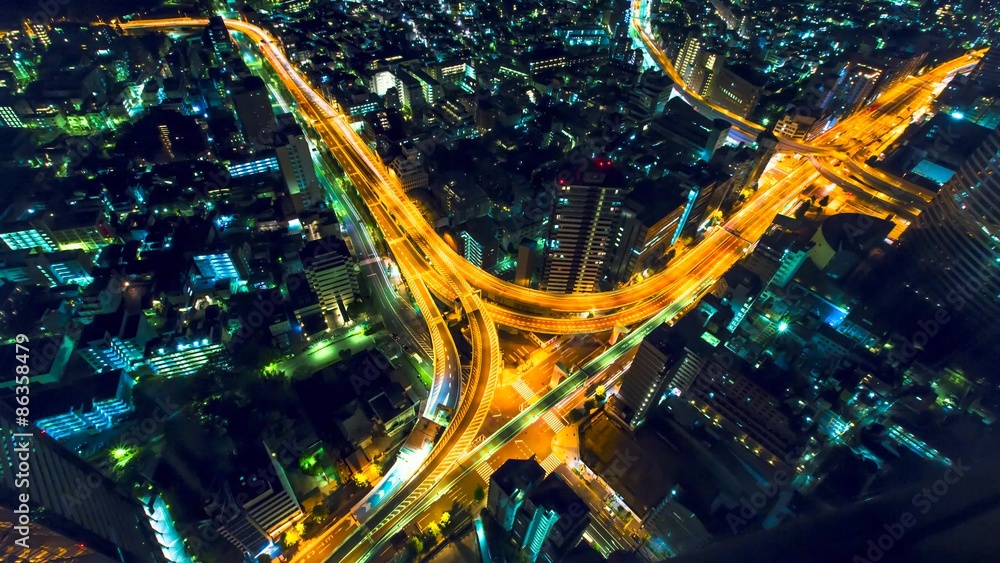Aerial view time-lapse of a massive highway intersection at night in Shinjuku, Tokyo, Japan. Aerial view time-lapse of a massive highway intersection at night in Shinjuku, Tokyo, Japan.