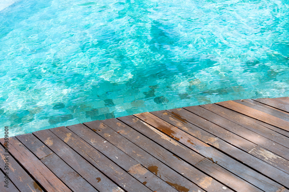 Wood floor beside the pool