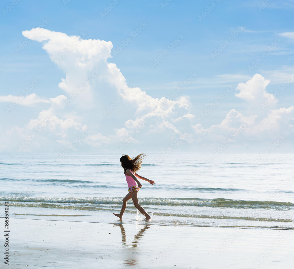 Little asian girl run on the beach