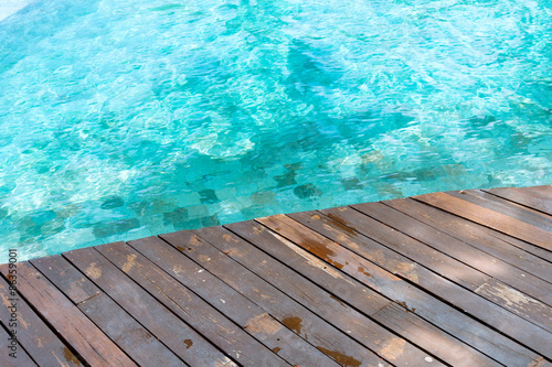 Wood floor beside the pool
