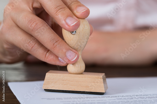 Person Hands Stamping Document