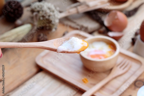 soft-boiled egg and eggs on wood background