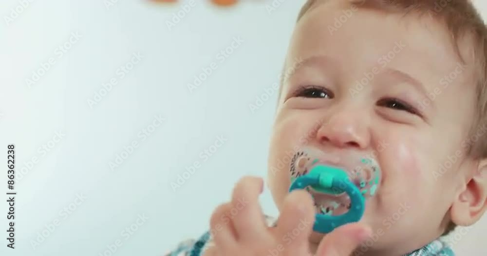 Little toddler in pyjamas crying and standing in his baby bed. Shoot on Digital Cinema Camera in 4K - ProRes 422 codec. Little toddler in pyjamas crying and standing in his baby bed. Shoot on Digital Cinema Camera in 4K - ProRes 422 codec.