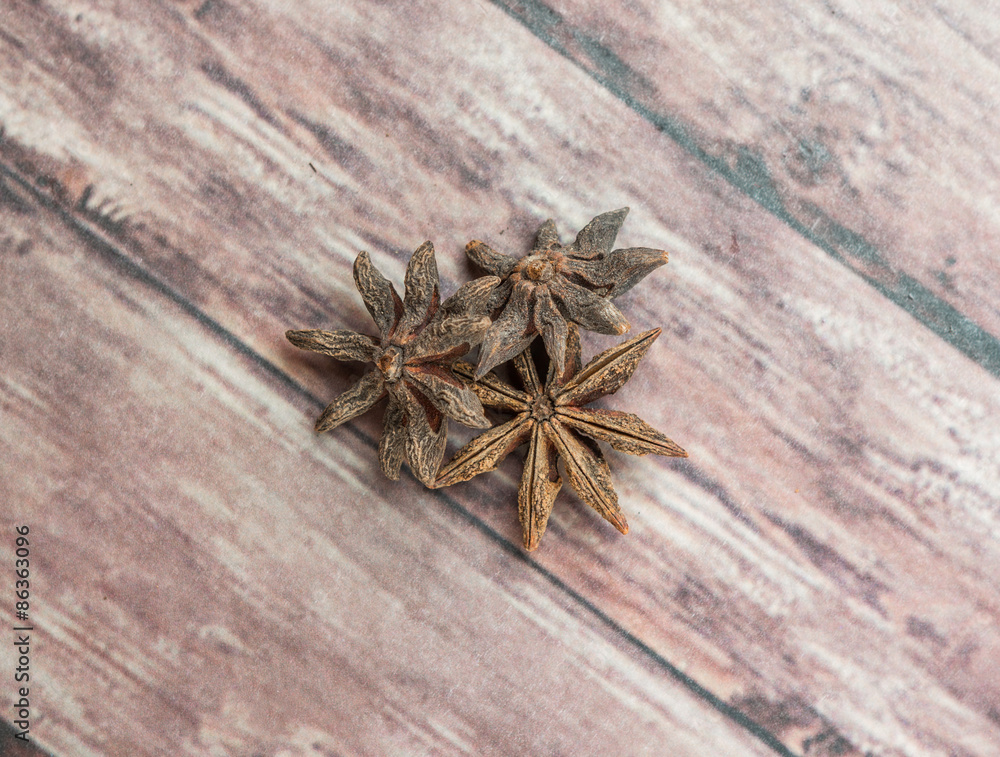Star anise spices over weathered wooden background Star anise spices over weathered wooden background