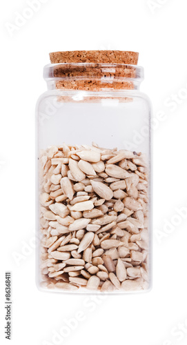 Sunflower seeds in a glass bottle with cork stopper, isolated on