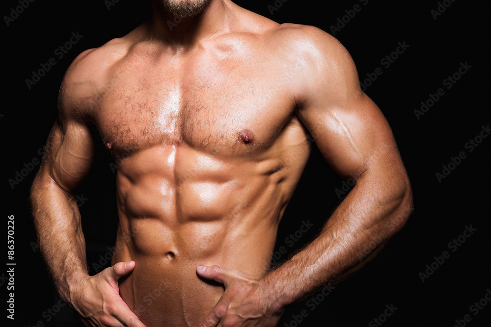 Muscular and sexy torso of young sporty man with perfect abs - obrazy, fototapety, plakaty 