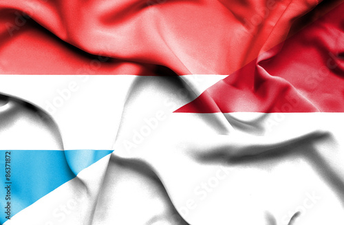 Waving flag of Monaco and Luxembourg