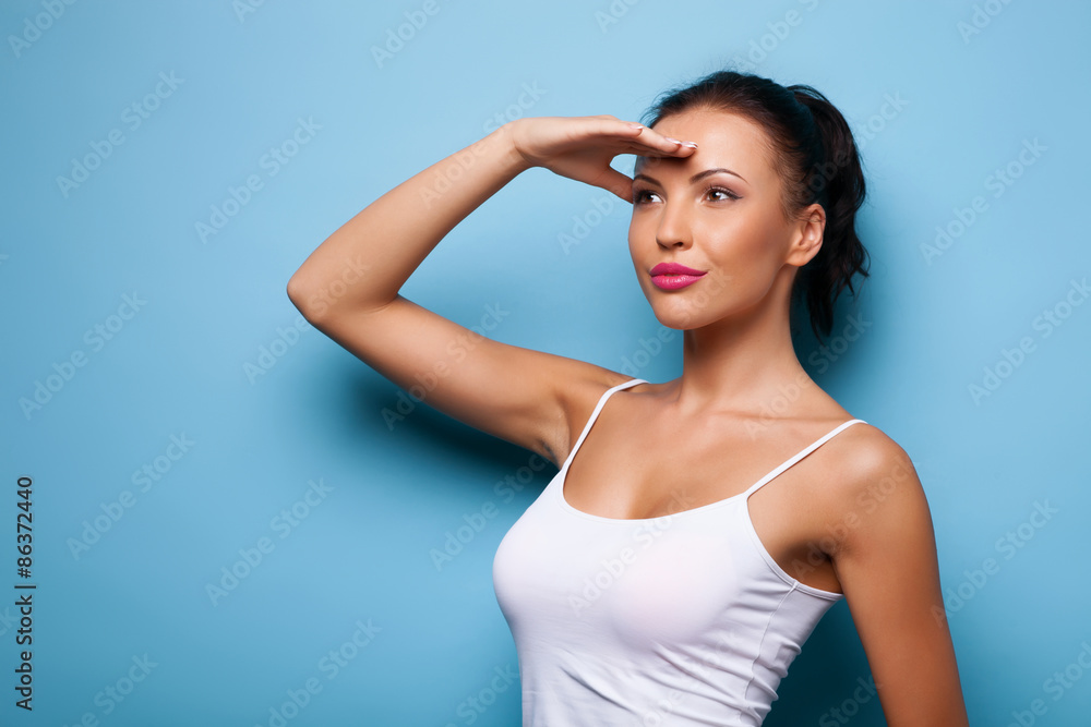 Cheerful young woman is trying to see something Cheerful young woman is trying to see something