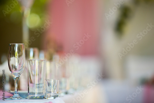 Three empty glasses on banquet table in restaurant