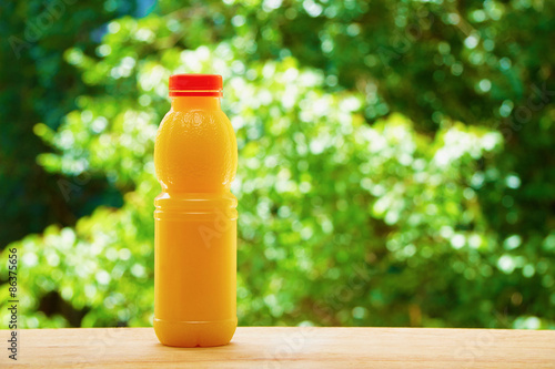 Bottle of orange juice on the wooden table