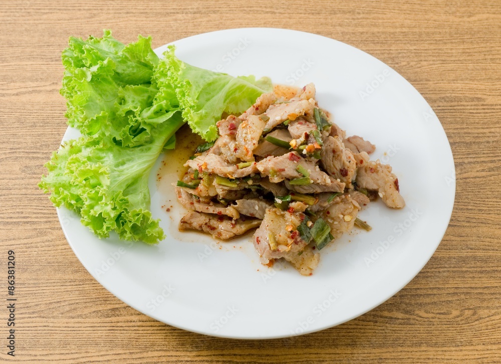 Plate of Spicy Grilled Beef Salad on Wooden Table Plate of Spicy Grilled Beef Salad on Wooden Table