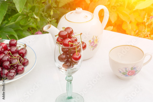 cherry tea cup glass table in a garden courtyard for summer tablecloth selective soft focus