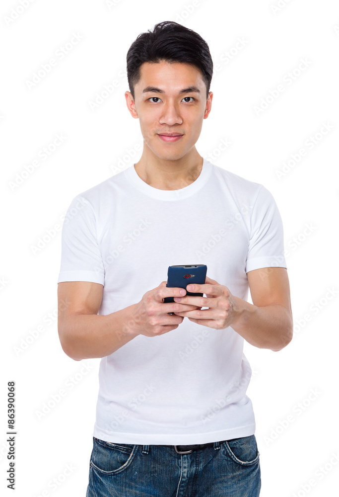 Asian man using the cellphone for playing game Asian man using the cellphone for playing game