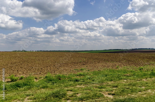 Background of sky, clouds and field with fallow