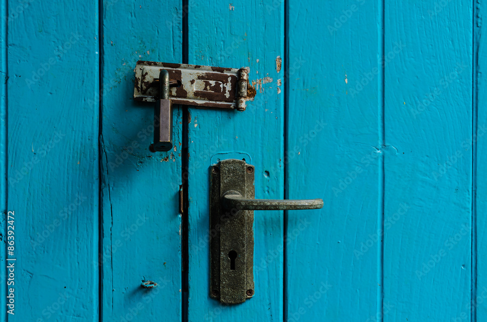Old door handle with retro wood plank texture background