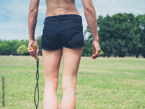 Rear view of woman with jump rope