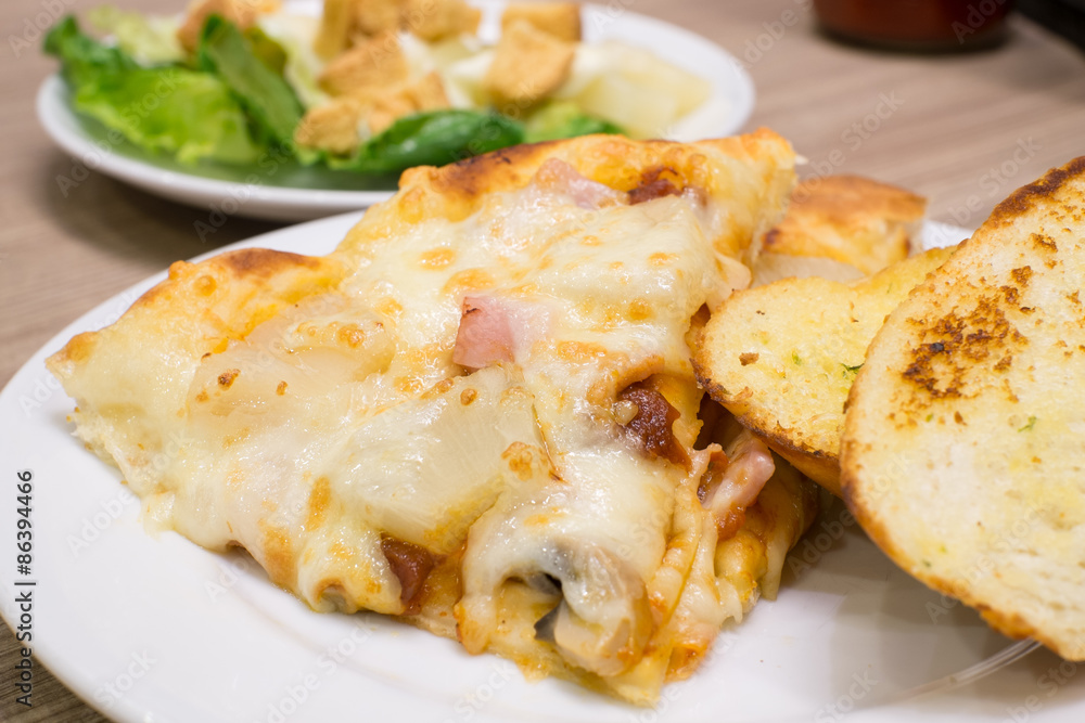 Closeup view of an appetising ham and pineapple Italian pizza wi Closeup view of an appetising ham and pineapple Italian pizza wi