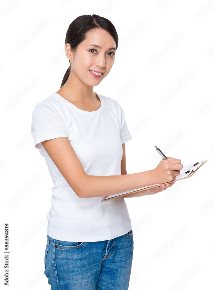Young woman take note on clipboard Young woman take note on clipboard