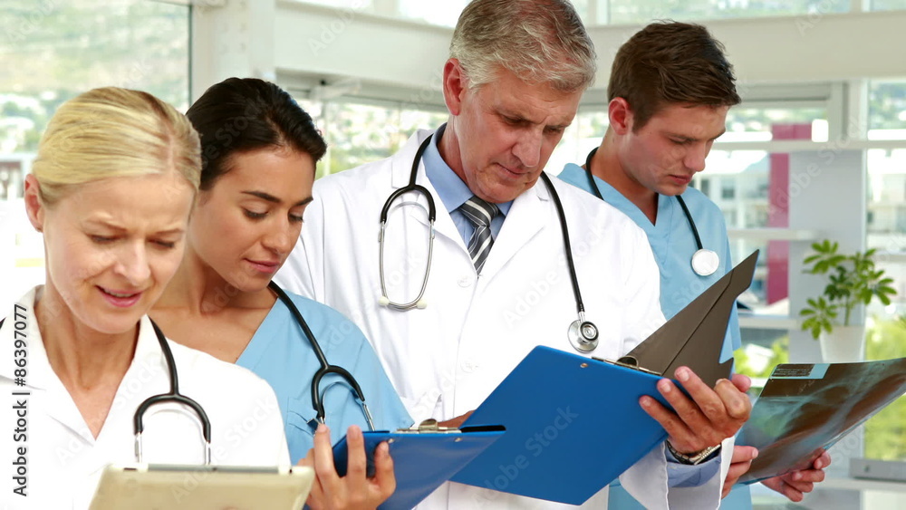 Serious medical team working in medical office Serious medical team working in medical office
