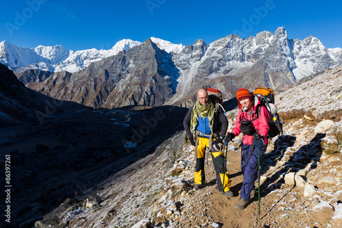 Couple happy backpackers standing Himalaya snow trail.