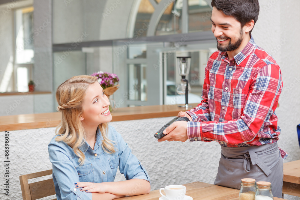 Waiter giving payment terminal to customer Waiter giving payment terminal to customer