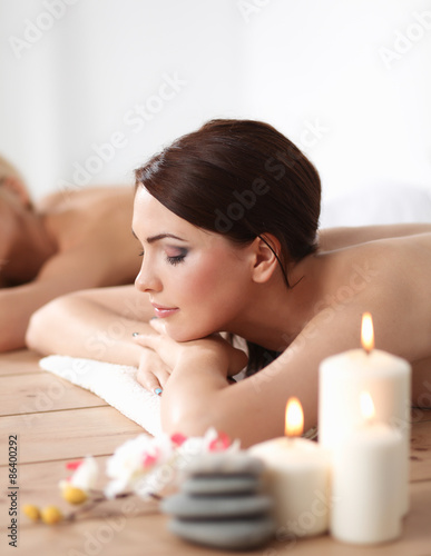 Two young beautiful women relaxing and enjoying at the spa