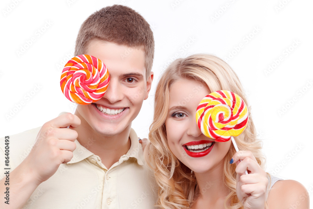 Smiling man and woman with candies 