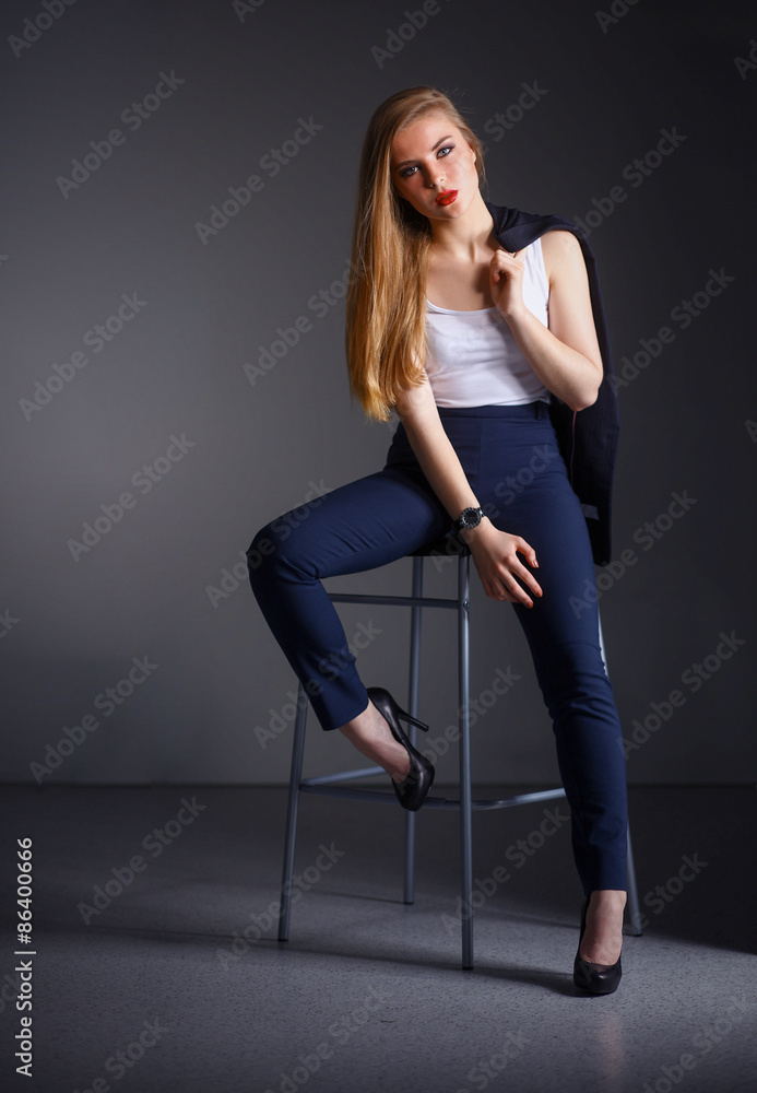 Young woman sitting on a chair Young woman sitting on a chair