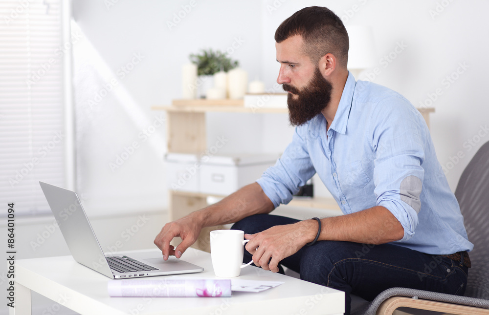 Young businessman sitting on chair in office