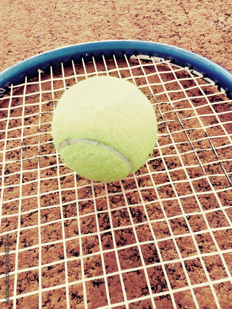 Tennis ball on racket