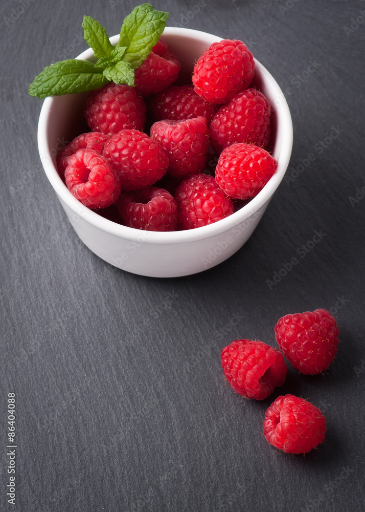Ripe sweet raspberries in bowl on table close-up Ripe sweet raspberries in bowl on table close-up