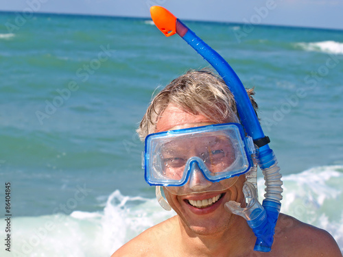 Diver wearing a mask on summer seaside.