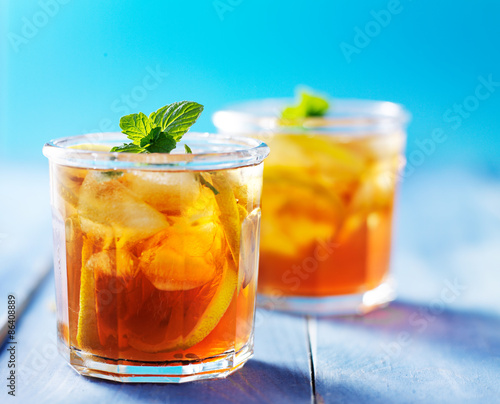 southern sweet tea in two cups on painted blue colorful table