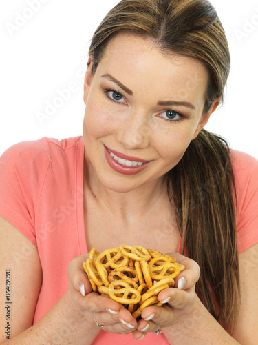 Attractive Young Woman Holding A Handful Of Salted Pretzels