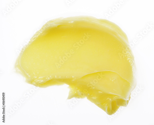 Yellow color skincare balm on background photo