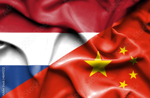 Waving flag of China and Netherlands