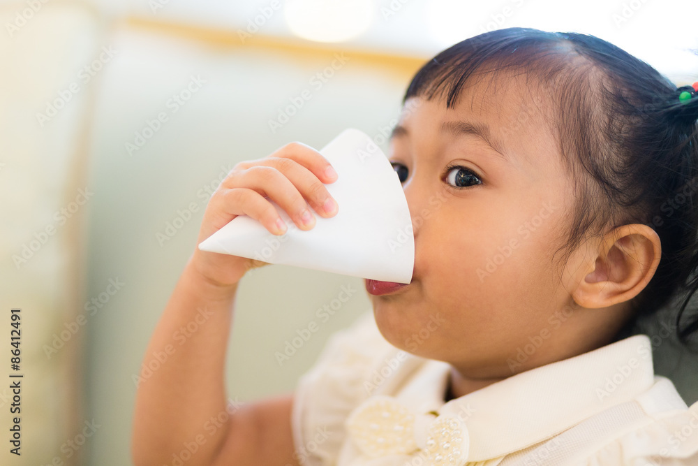 Little girl feel thirsty and drinking a paper cup of water Little girl feel thirsty and drinking a paper cup of water