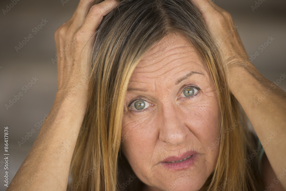 Scared woman with hands on head Scared woman with hands on head