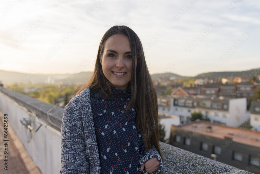 Portrait of a beautiful young brunette with long hair posing on