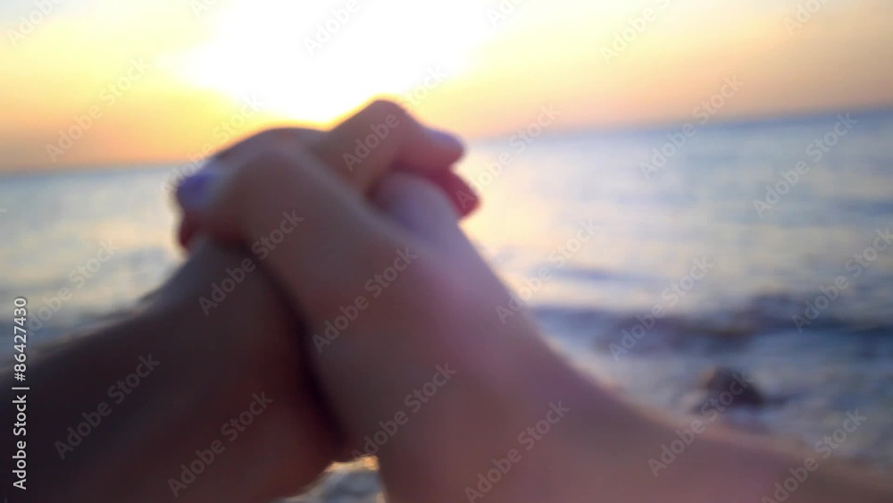 Couple in love holding hands at sunset in the beach Couple in love holding hands at sunset in the beach