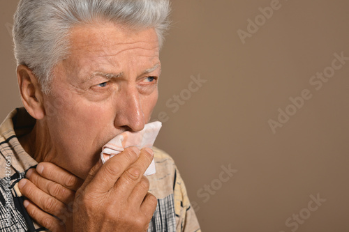 Sick old man on grey background 