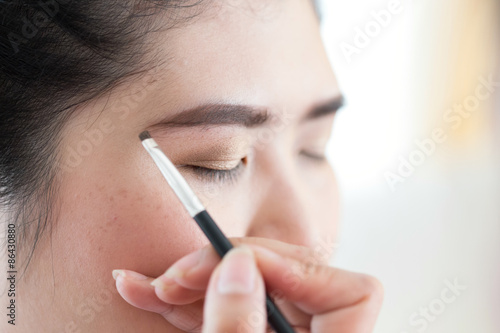 makeup beauty with brush eyebrow on pretty woman © sutichak