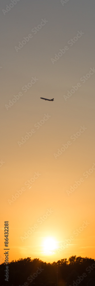 airplane in front of a hot evening sun