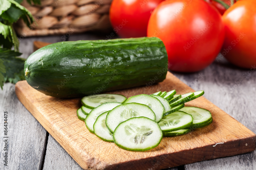 Chopped vegetables: cucumber on cutting board Chopped vegetables: cucumber on cutting board