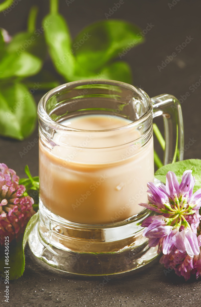 Irish liqueur and clover, selective focus Irish liqueur and clover, selective focus