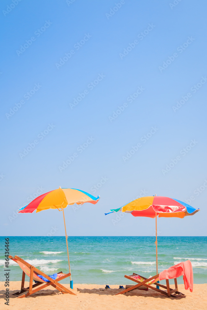 Obraz premium Beach chair and umbrella on sand beach