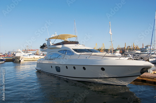 White yacht in the port. On the sea calm.